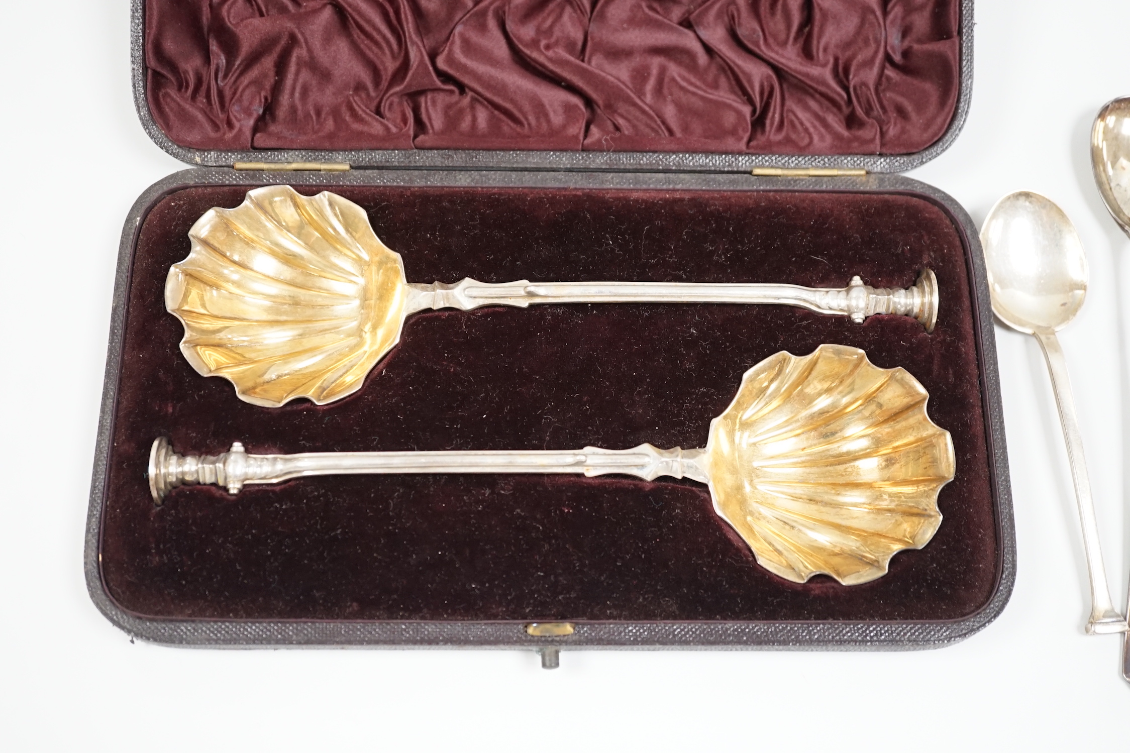 A cased pair of Victorian silver seal top serving spoons, Francis Higgins, London, 1887, 21.5cm, four other sundry silver spoons and a silver mounted hand mirror.